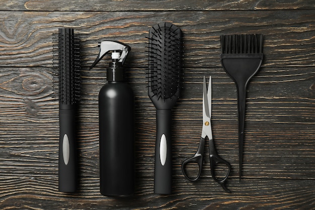 Flat lay with hairdresser accessories on wooden