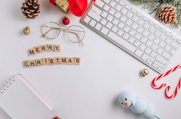 Flat lay with keyboard, candy cane, gift, and cones