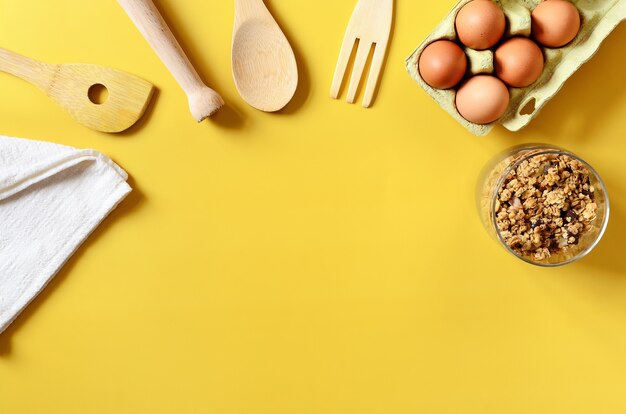 Flat lay with kitchen and cooking utensils on yellow background Culinary blog recipe template