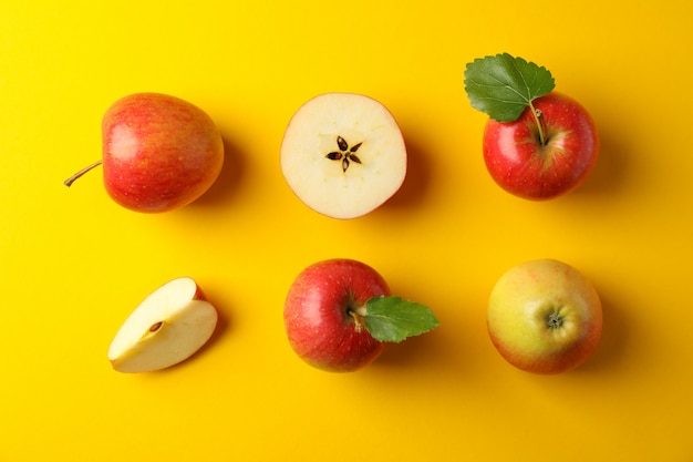 Flat lay with red apples on yellow table