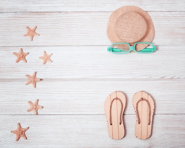 Flat lay with summer shoes, hat and starfish