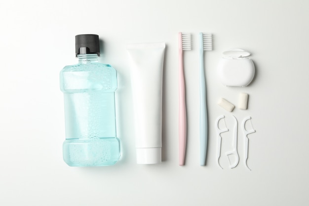 Flat lay with tools for dental care on white background