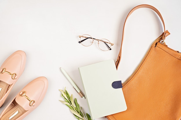 Flat lay with woman fashion accessories in neutral colors