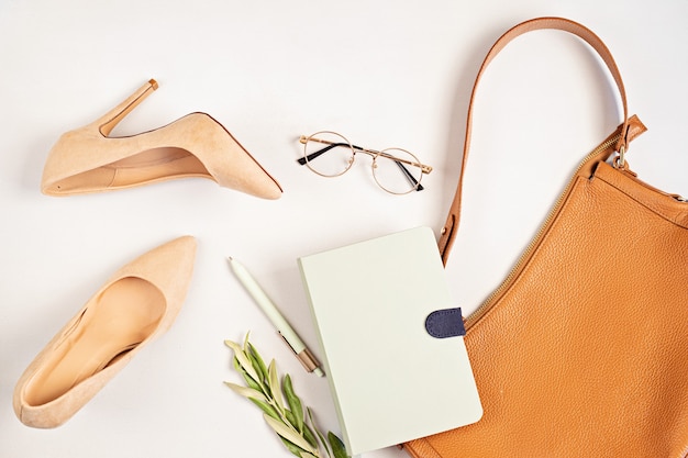 Flat lay with woman fashion accessories in neutral colors