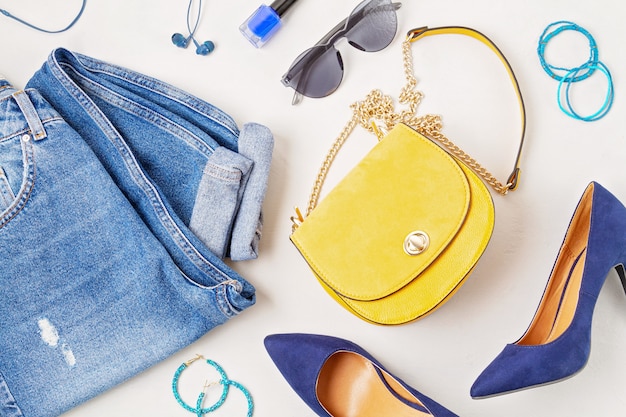 Flat lay with woman fashion accessories in yellow and blue colors