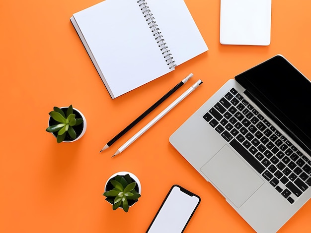 Photo flat lay workspace with notepad coffee laptop and plant on orange background