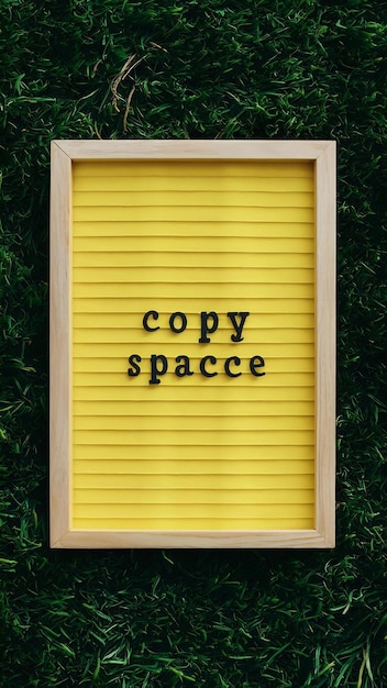 Flat lay of yellow frame with copy space