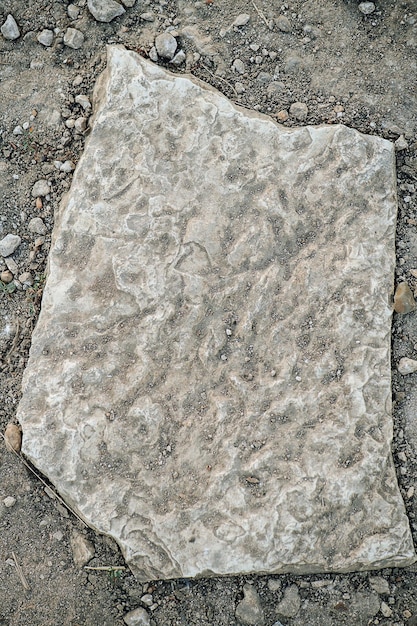 Flat limestone in a dirt Top view Earth and sand in grooves