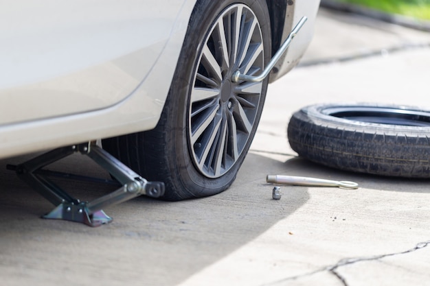 Flat tire the bolts nuts with a wrench and spare wheel replacing wheel, changing tire on car, Repairing and maintenance concepts