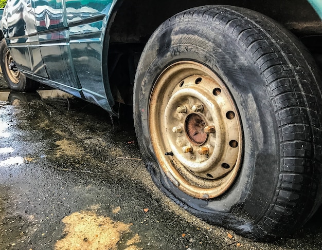 Flat Tire of an old car on the road