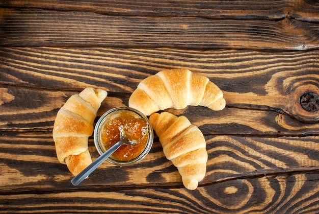 Flatlay of fresh croissants with fig jam for breakfast Top view Selective focus