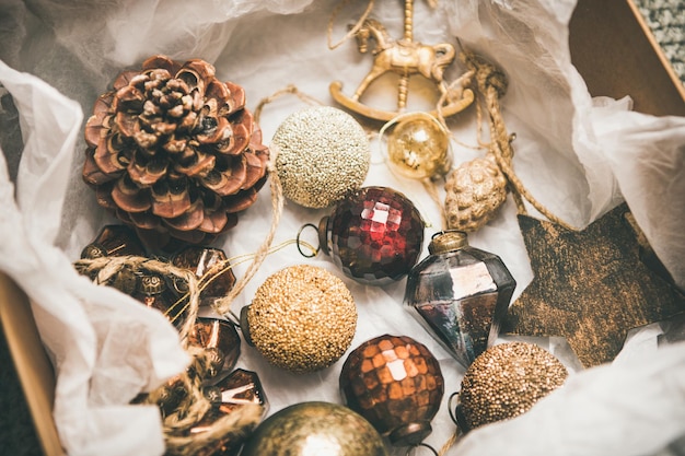 Flatlay of various vintage Christmas tree decoration toys in box