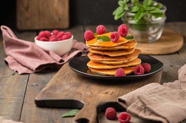 flavored pancakes with honey and fresh raspberries for breakfast