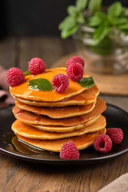 flavored pancakes with honey and fresh raspberries for breakfast