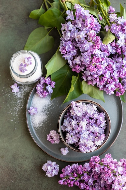 Flavored sugar with lilac flowers and branch of lilac Edible flowers in cooking and confectionery