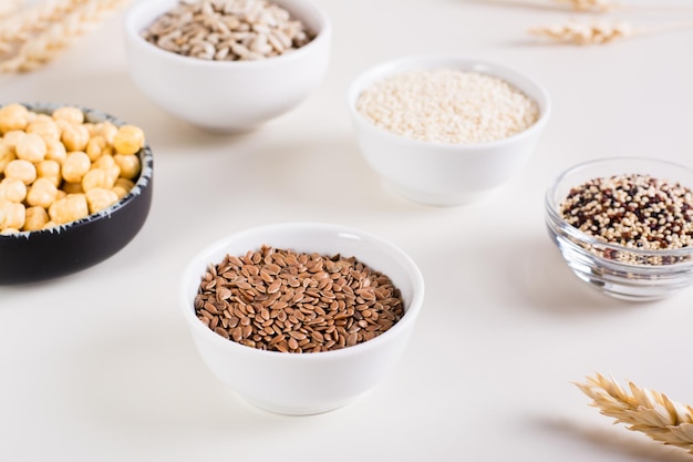 Flax seeds in a bowl and other seeds in bowls on the table Healthy food