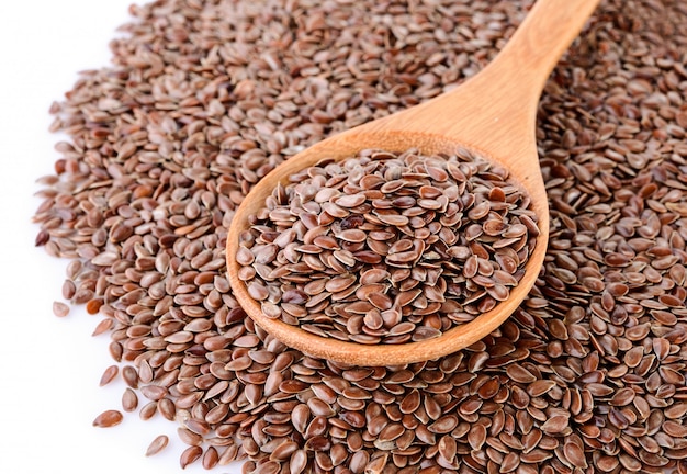 Flax seeds heap in wood spoon