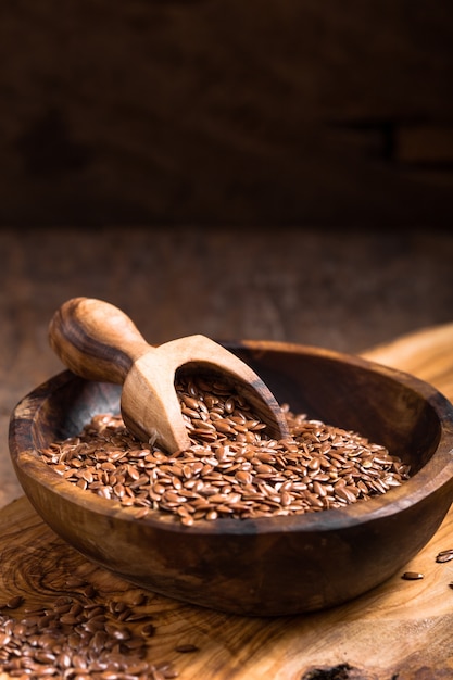 Flax seeds or line in bowl on wooden table