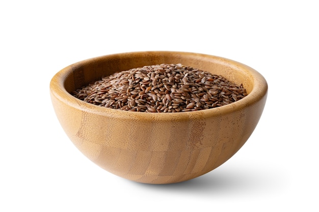 Flax seeds in a wooden bowl on a isolated on a white surface