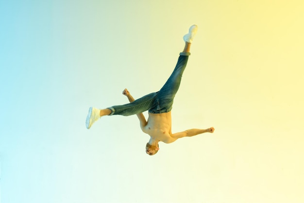 Flexible acrobat jumping upside down