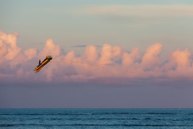 Flight on a rubber boat over the ocean, driven by a boat. Water activities in Bali.