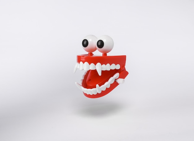 Photo floating clockwork jaw with vampire fangs on white background with shadow