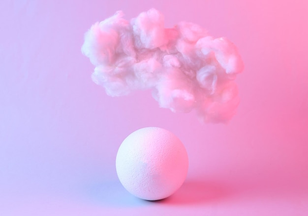 Floating fluffy cloud with ball in blue pink neon gradient light Creative idea Creative art Minimalism