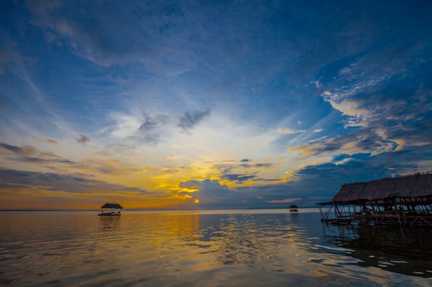 Floating house on the embankment with Sunset Background