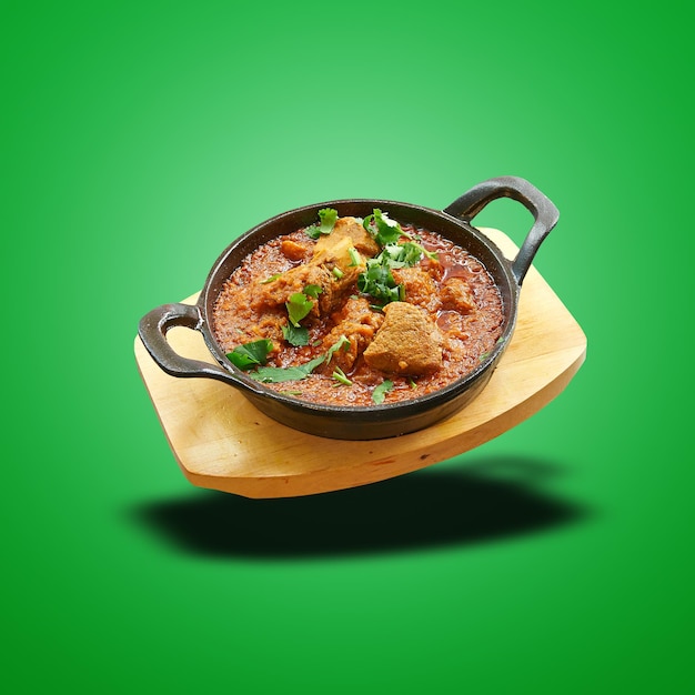 Floating lamb karahi baked in little pan on green