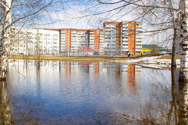 Flooding in the city Multistorey colorful houses are reflected in the water