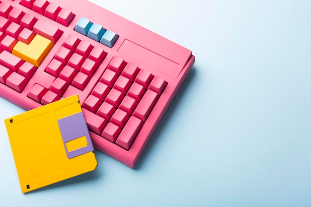 Floppy disks and keyboard on bright colored backgrounds