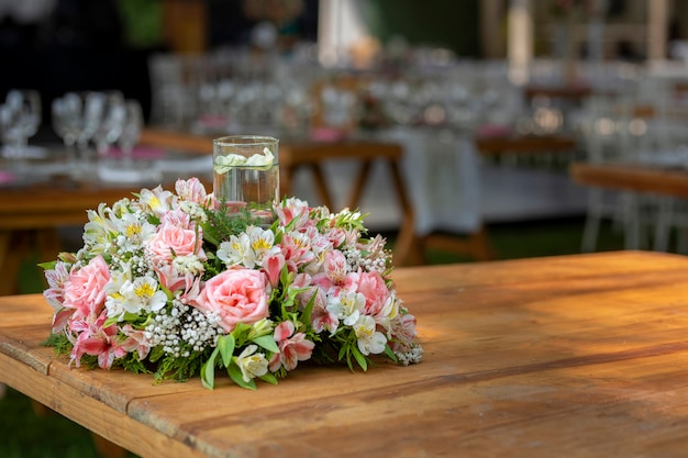 Floral arrangement on a wooden table at a social event in Mexico