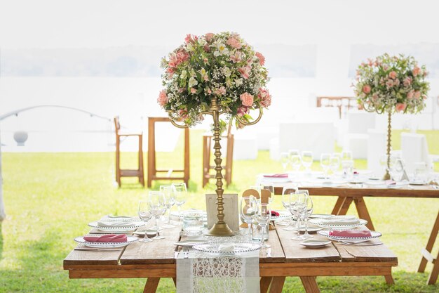 Floral arrangement on a wooden table with crystals set up in a garden for a social event in Mexico