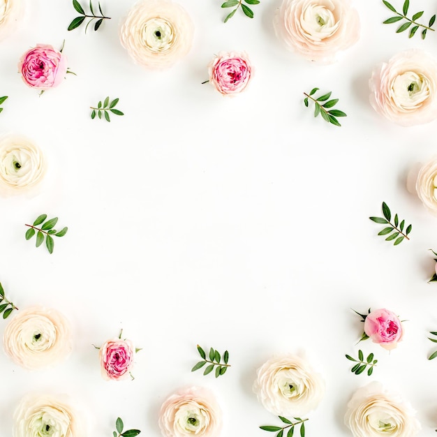 Floral background frame made of pink ranunculus and roses flower buds on white background flat lay t