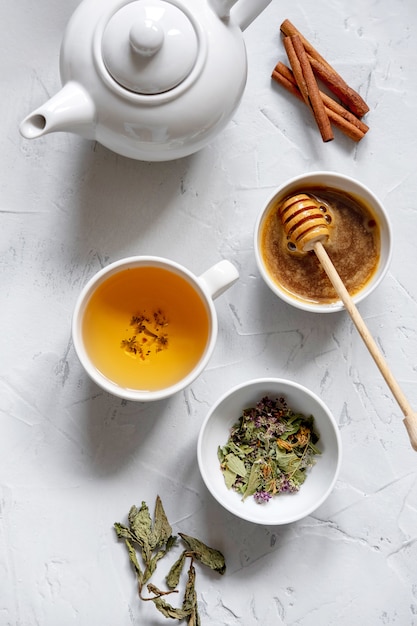 Floral green tea on table with tea kettle and napkin