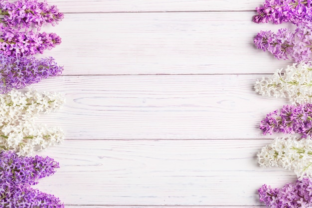 Floral pattern lilac branches and petals on wooden. Frame.