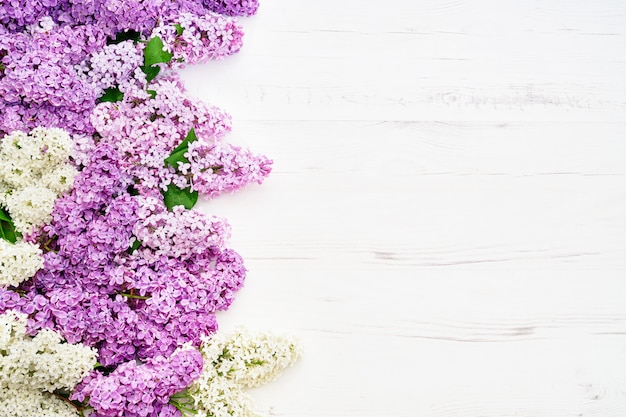 Floral pattern of pink lilac branches, flowers background. Flat lay, top view.