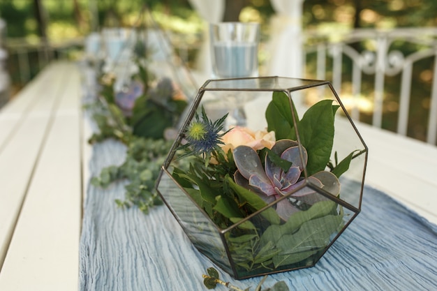 Florarium with fresh succulent and rose flowers festive table decoration