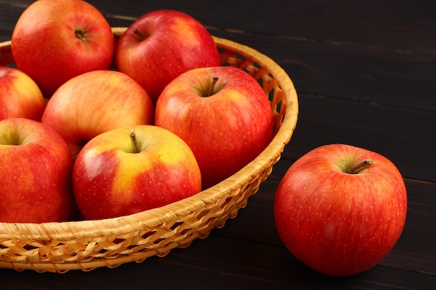 Florin apples in a basket on a dark surface