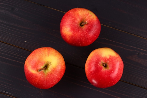 Florin's red apples on a dark surface