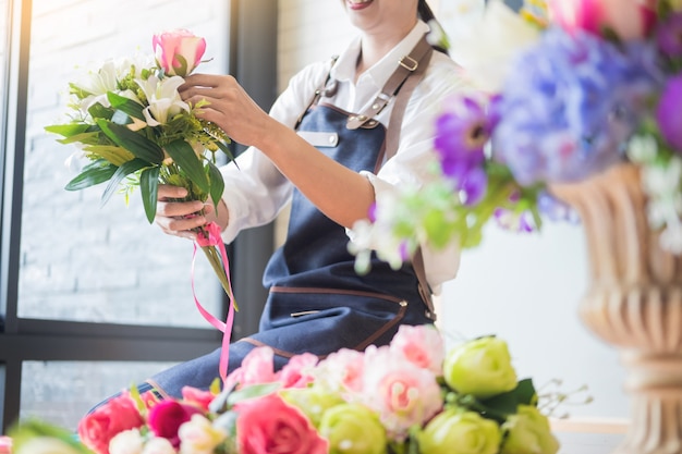 Florist  Arranging beautiful Artificial vest at flower shop, business floristry concept