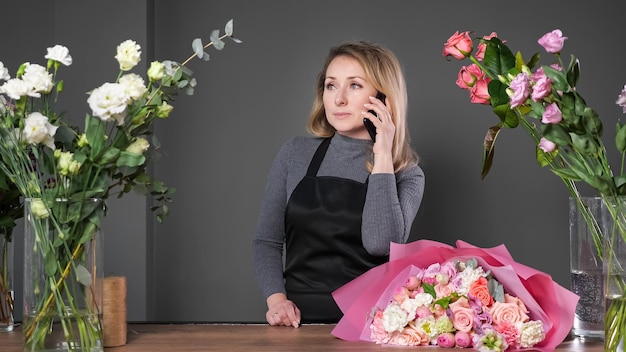 Florist informs customer about composed flowers bouquet