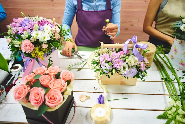 The florist makes the bouquet top view on background white Board