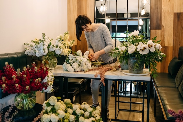 Florist making bouquet in flower shop