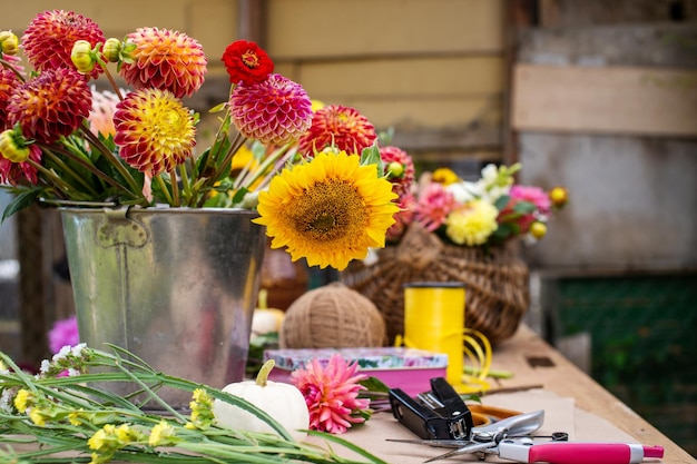 Florist's workplace with dahlias and sunflowers