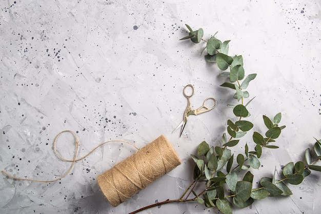 Florist tools and workplace with ribbons, flowers and scissors