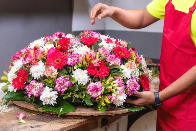 Florist at work. Male florist creating beautiful bouquet at flower shop. 