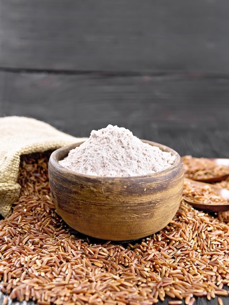 Flour red rice in bowl on board