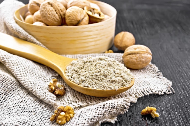 Flour walnut in spoon on burlap