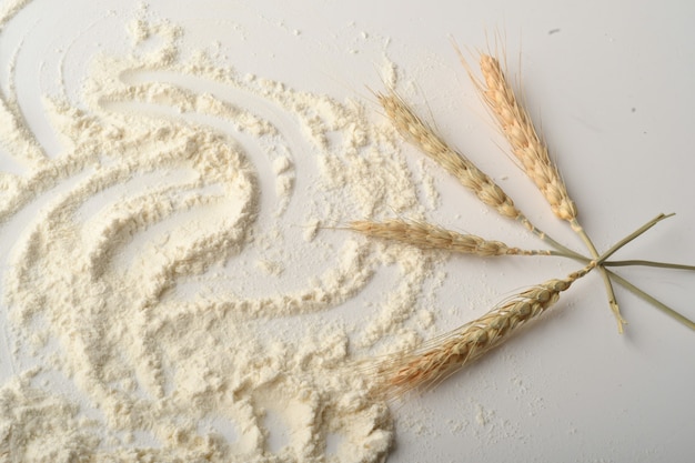 Flour, wheat, rice, raisins and coins on a white background